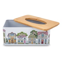 Rectangular light blue metal tissue box with colorful house design and natural wood top, on a wooden coffee table. - view 4