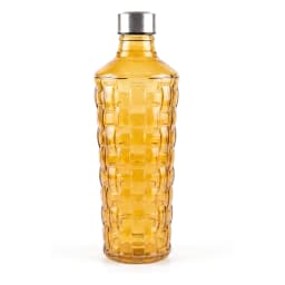 Single amber glass bottle with a textured, basket-weave pattern and a silver cap, standing on a white shelf. - view 2