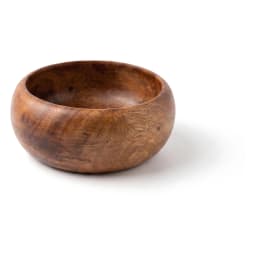 Dark brown wooden salad bowl filled with fresh green salad, cucumbers, and cherry tomatoes on a light countertop. - view 2