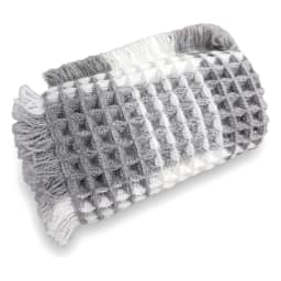 Rectangular grey and white checkered waffle-textured bath mat with fringed edges on a white background. - view 2