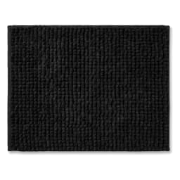 Top-down view of a rectangular black runner mat with a soft, textured bobble-like fabric surface on a white background. - view 2