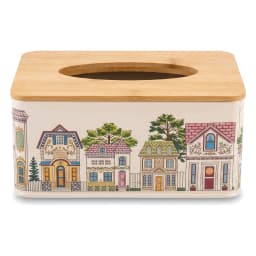 Rectangular cream metal tissue box with a colorful village illustration and a light brown wooden lid, on a white surface. - view 3