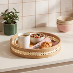 Set of three round natural light brown bamboo serving trays stacked, with perforated decorative rims on a white background. - view 6