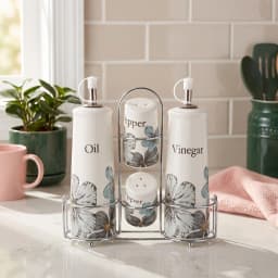 Cream porcelain oil and vinegar dispensers with salt and pepper shakers, all with blue floral design, in a silver metal stan… - view 1