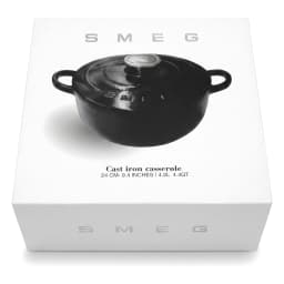 Black cast iron pot with its lid slightly ajar, filled with a steaming beef and carrot stew, on a light tiled kitchen counte… - view 2