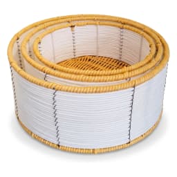 Set of three round khous storage baskets in white and natural colors, holding rolled towels, folded clothes, and books on a… - view 2