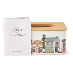 White rectangular metal tissue box with a light brown wooden lid, decorated with a colorful village street scene. - view 2