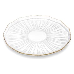 Three clear ribbed glass plates with gold rims, one large and two small, holding berry tarts on a kitchen counter. - view 3
