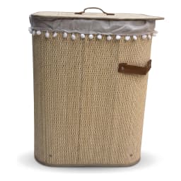 Tall, cylindrical beige khous laundry hamper with a lid, light grey fabric liner with white pom-poms, and brown faux leather… - view 2