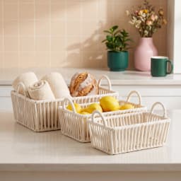 Three rectangular cream Khous storage baskets with handles, nested inside each other, on a shelf. - view 3