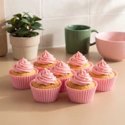 Two pink fluted silicone cupcake molds visible in clear plastic packaging, indicating a set of 6 molds. - view 1