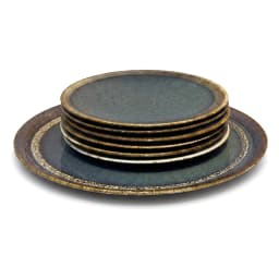 Two round deep blue ceramic plates with rustic gold rims, one large with a carrot cake, one small with a slice, on a white c… - view 4