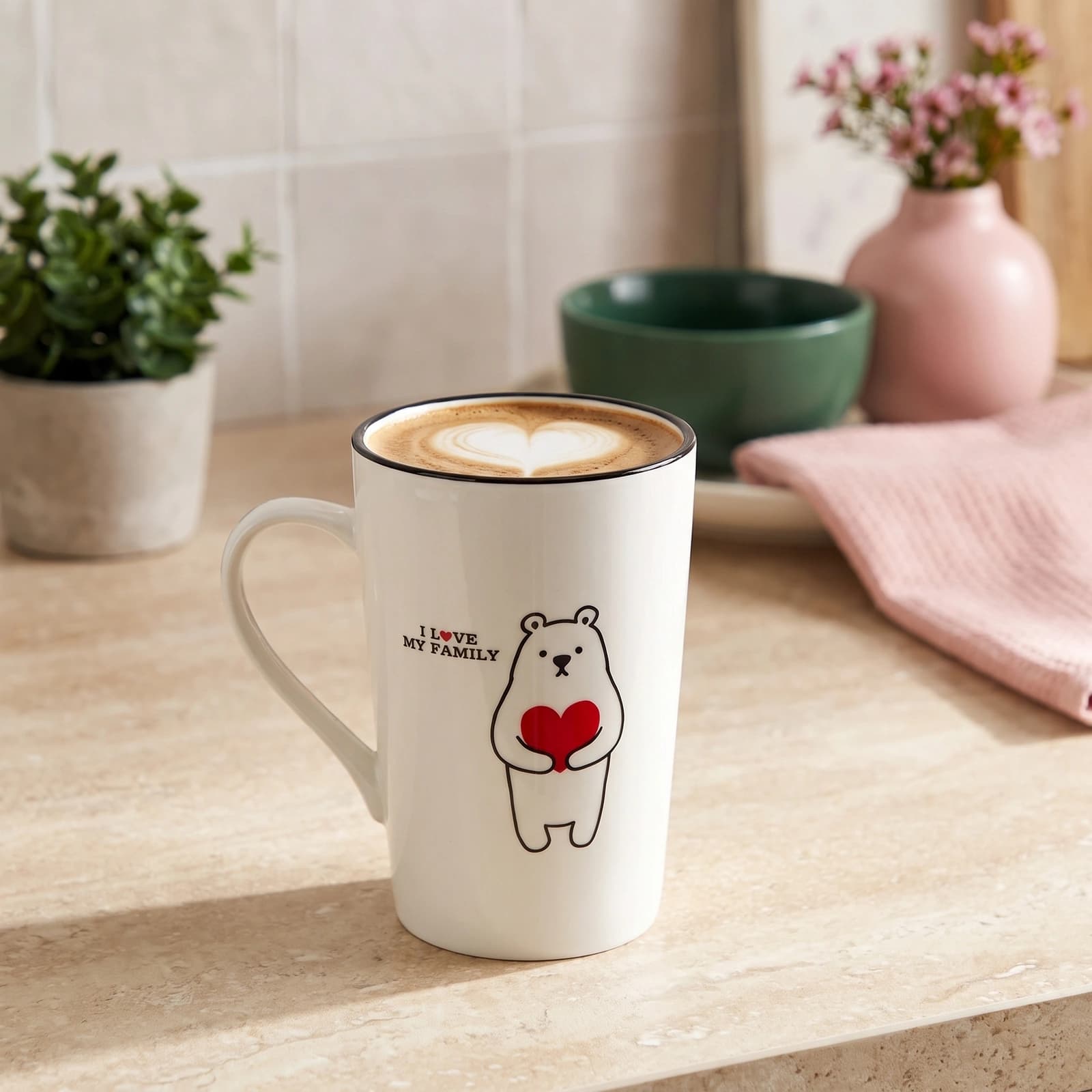 White ceramic mug with a black rim and a cartoon bear holding a red heart, text 'I LOVE MY FAMILY' on a white shelf.