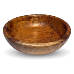 Round natural brown wooden serving bowl filled with fresh green salad on a light marble kitchen counter - view 2