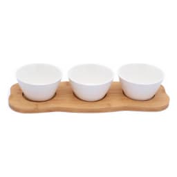 Three white porcelain serving bowls with embossed patterns on a light brown wooden tray, isolated on white. - view 3