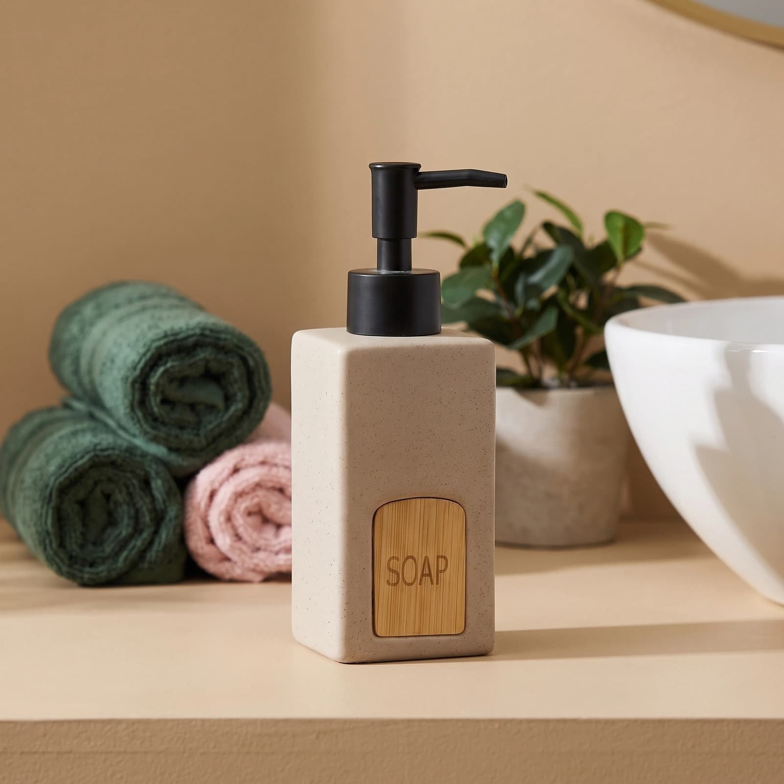 Beige speckled ceramic soap dispenser with square body, black plastic pump, and a light wood-look label saying 'SOAP'.
