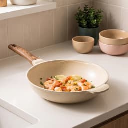 Beige granite deep wok pan 28cm with a wood-look handle, shown on its product box with shrimp and lemon. - view 1