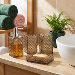 Four-piece smoky grey acrylic bathroom set with geometric texture, including soap dispenser, soap dish, tumbler, and toothbr… - view 1
