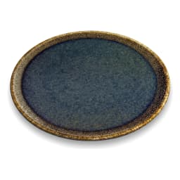 Two round deep blue ceramic plates with rustic gold rims, one large with a carrot cake, one small with a slice, on a white c… - view 3