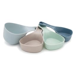Set of 4 plastic measuring cups and spoons in light blue, beige, mint green, and dark blue on a white background. - view 3