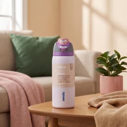 Light purple insulated stainless steel water bottle with grey and pink push-button lid and built-in straw on a wooden table. - view 1