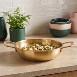 Round gold stainless steel frying pan with two loop handles, isolated on a white background - view 1