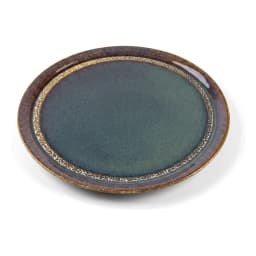 Two round deep blue ceramic plates with rustic gold rims, one large with a carrot cake, one small with a slice, on a white c… - view 2