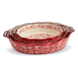 Set of three oval red porcelain baking dishes with cream interiors and red floral patterns, arranged on a white background. - view 2