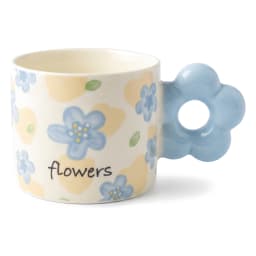 Cream ceramic mug with light blue floral pattern and a unique light blue flower-shaped handle on a white shelf. - view 2