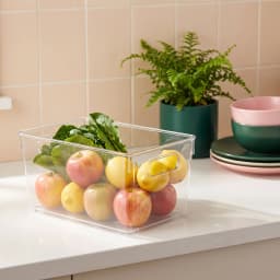 Transparent rectangular acrylic storage bin with integrated handles on a white shelf - view 1
