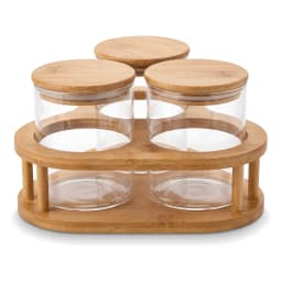 Three clear glass storage jars with light brown wooden lids, arranged on a light brown wooden stand, on a white background. - view 2
