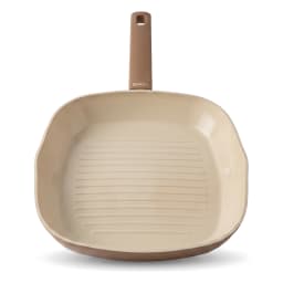 Square ceramic grill pan in beige and cream color, filled with grilled chicken skewers and vegetables on a kitchen counter. - view 3