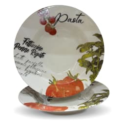 Two white porcelain pasta plates with red tomato and green basil design, filled with pasta, on a white kitchen counter. - view 2