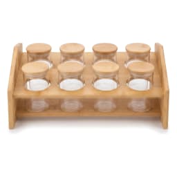 Eight clear glass spice jars with light brown wood lids on a two-tier natural wood storage rack on a white background. - view 2