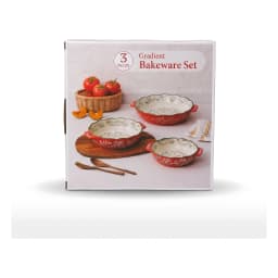 Set of three red granite oval baking dishes with white floral interior and green scalloped rim, shown on a kitchen counter. - view 2