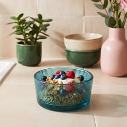 Round teal ribbed glass serving bowl on a white background, showing textured horizontal lines on the exterior. - view 1