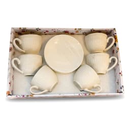Six cream porcelain coffee cups with ribbed design and matching saucers, filled with coffee, on a rustic wooden table in a l… - view 4