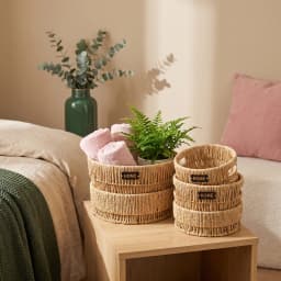 Set of three round natural khous woven storage baskets with 'HOME' tags, varying in size, on a white background. - view 3