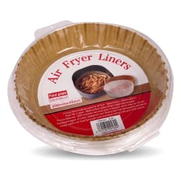 Stack of brown round air fryer paper liners in clear packaging next to a dark green air fryer with fries inside. - view 2