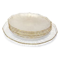 Three clear ribbed glass plates with gold rims, one large and two small, holding berry tarts on a kitchen counter. - view 2