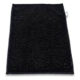 Top-down view of a rectangular black runner mat with a soft, textured bobble-like fabric surface on a white background. - view 3
