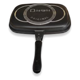 Open black granite double-sided grill pan with red trim, cooking grilled chicken, asparagus, and tomatoes on a kitchen count… - view 3