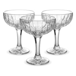 Three clear glass coupe glasses with textured bowls and starburst bases on a white background - view 3