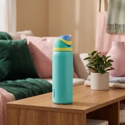 Teal and lime green stainless steel insulated water bottle with a push-button lid and built-in straw, 945ml capacity. - view 1