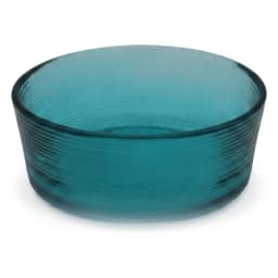 Round teal ribbed glass serving bowl filled with fresh salad on a kitchen counter, with pink mug and vase in background. - view 3