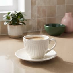 Six cream porcelain coffee cups with ribbed design and matching saucers, filled with coffee, on a rustic wooden table in a l… - view 5