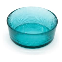 Round teal ribbed glass serving bowl filled with fresh salad on a kitchen counter, with pink mug and vase in background. - view 2