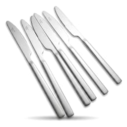 Six silver stainless steel dinner knives with serrated edges, arranged diagonally on a white background. - view 3