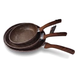 Two brown speckled granite fry pans with wood-look handles, one nested inside the other, on a kitchen counter with garlic an… - view 3