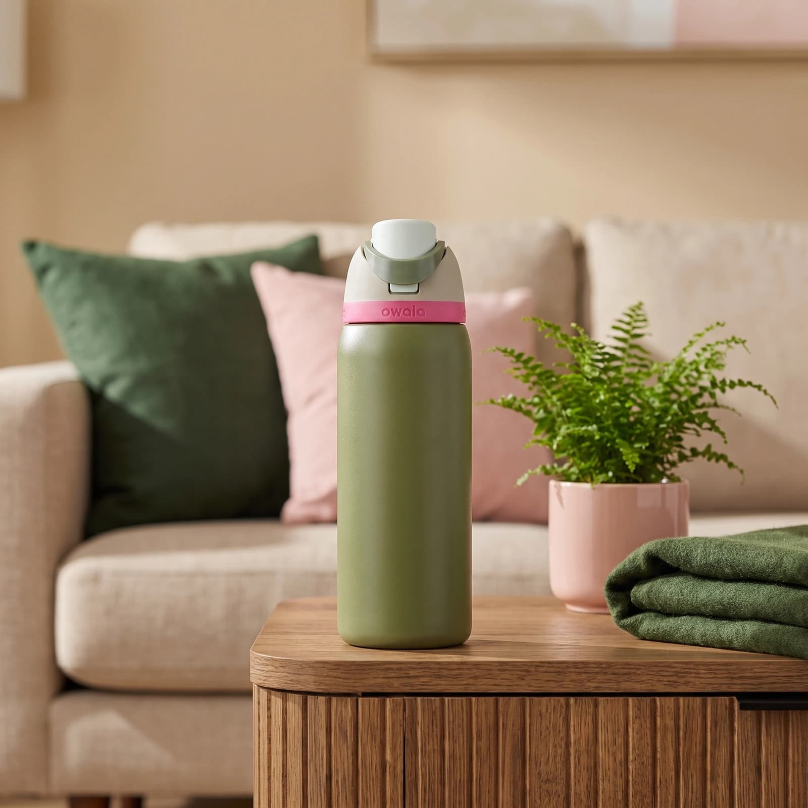 Olive green stainless steel insulated water bottle with a light green and pink push-button lid, 945ml capacity.